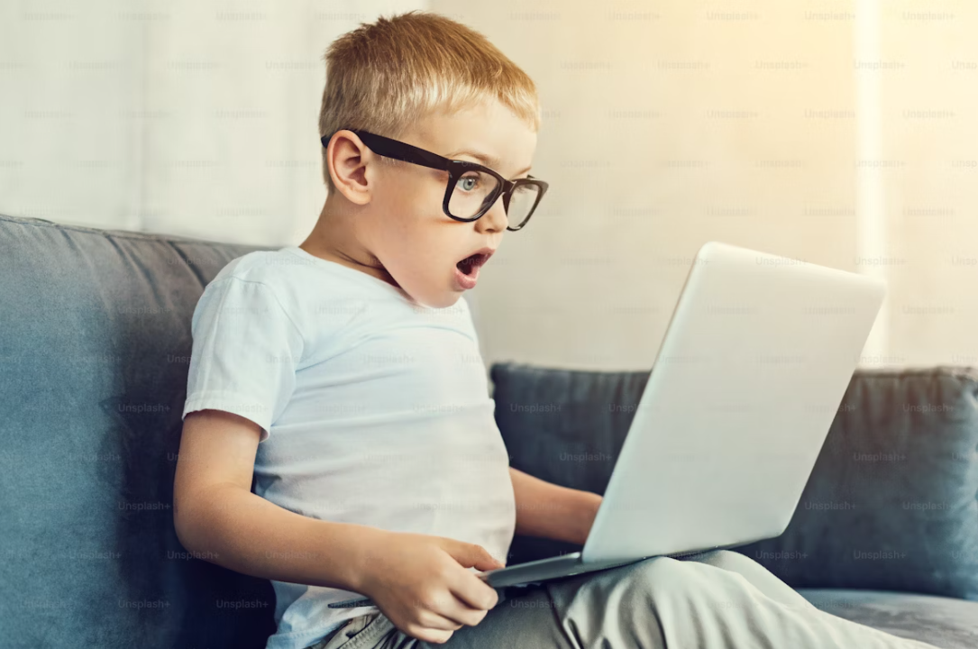 Enfant surpris devant un ordinateur